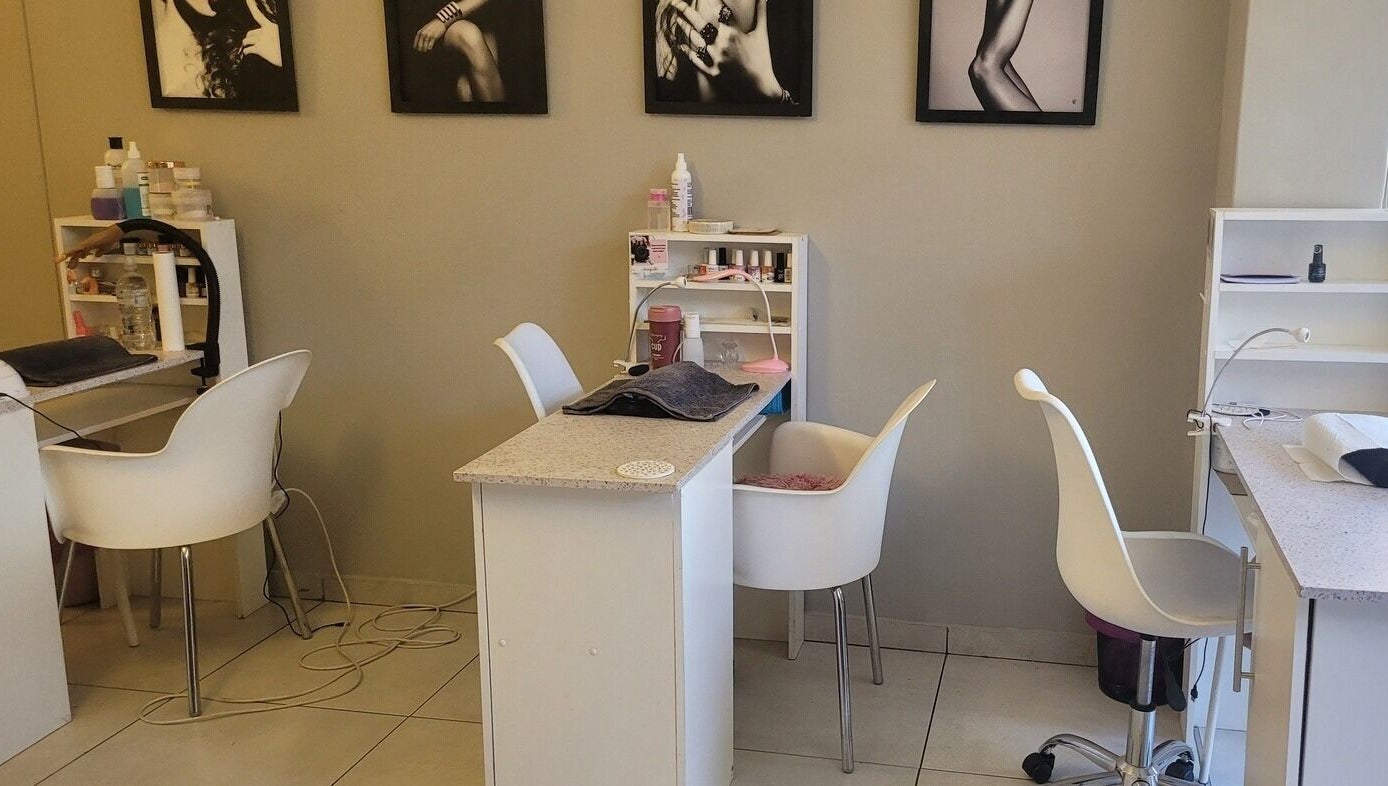Modern nail salon setup at Divine Sparkle, Randburg, Gauteng, ZA, featuring stylish chairs and manicure stations.