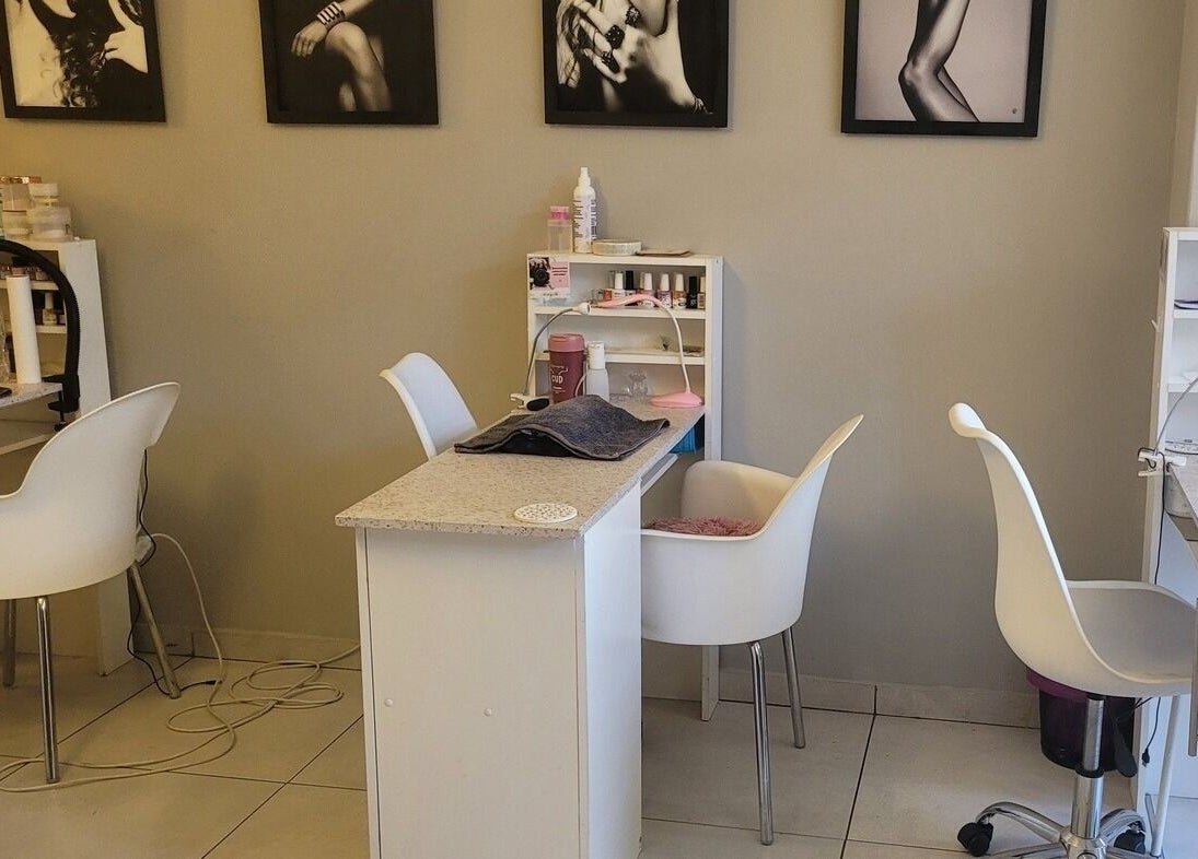 Modern nail salon setup at Divine Sparkle, Randburg, Gauteng, ZA, featuring stylish chairs and manicure stations.