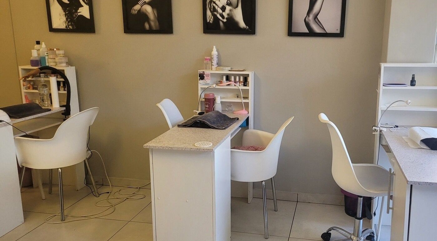 Modern nail salon setup at Divine Sparkle, Randburg, Gauteng, ZA, featuring stylish chairs and manicure stations.