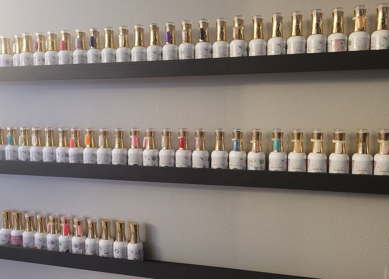 Rows of nail polishes at Divine Sparkle, Randburg, Gauteng, ZA enhance beauty services.