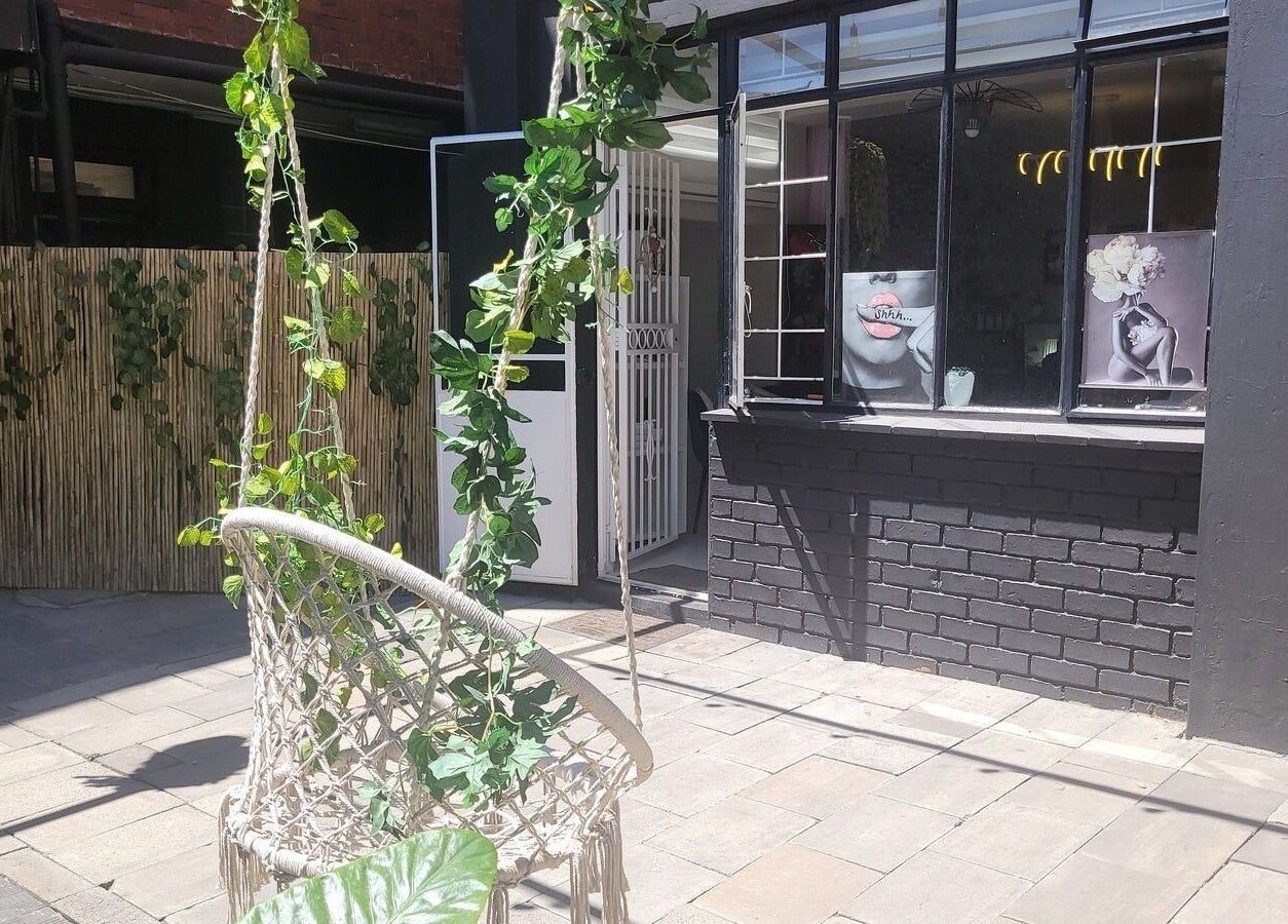 Garden seating at Divine Sparkle, Randburg, Gauteng, ZA, showcasing lush greenery and peaceful ambiance.