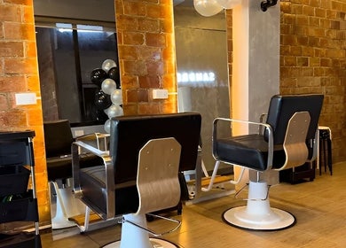 Interior of Sandrea Salon Parañaque with stylish chairs and brick walls, Parañaque, Metro Manila, PH.