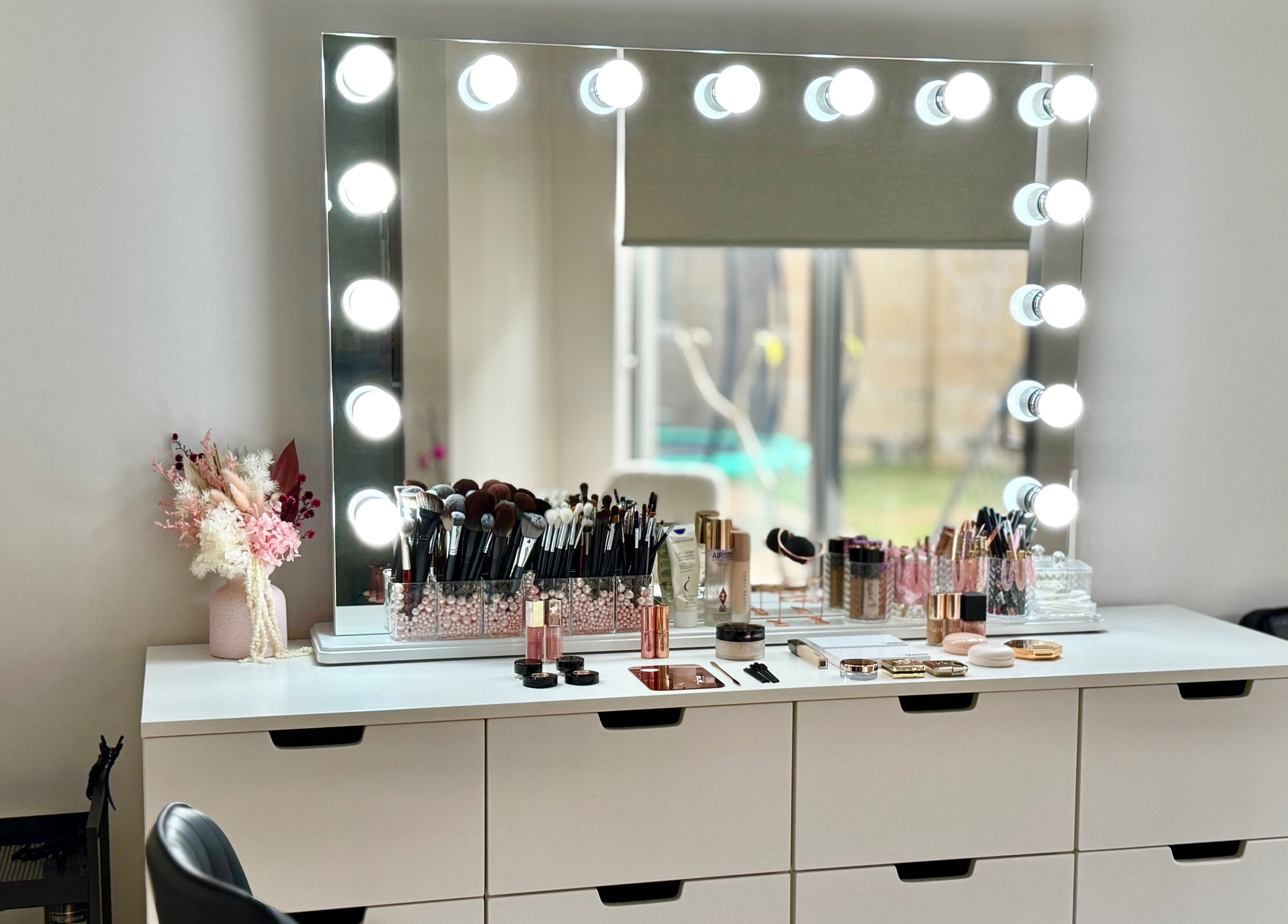 Makeup vanity at Kateryna Glowmakeup in Yokine, Western Australia, AU, featuring cosmetics and bright lights.