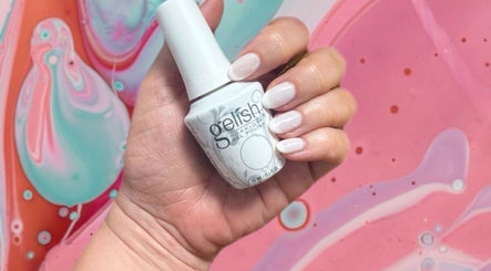 Elegant hand with gel polish bottle at Nadine's Nail & Beauty Bar Techno Park Stellenbosch, Western Cape, ZA.