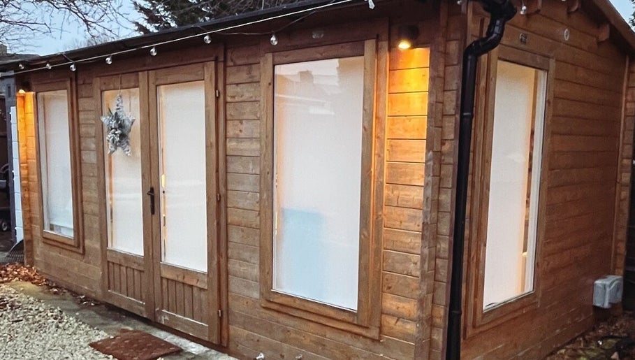 Exterior of Jayme’s Home Studio in Hornchurch, England, GB, featuring rustic wood design and peaceful ambiance.