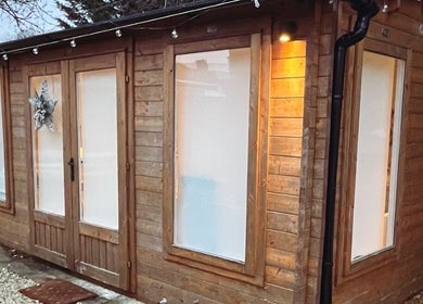 Exterior of Jayme’s Home Studio in Hornchurch, England, GB, featuring rustic wood design and peaceful ambiance.