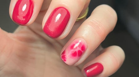 Close-up of elegant red nail art at Jayme’s Home Studio, Hornchurch, England, GB.