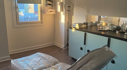 Relaxing treatment room at The Aesthetics Room in Linwood, Scotland, GB with bed and equipment.