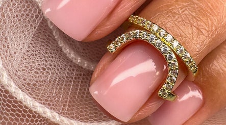 Close-up of a delicate pink nail design with gold accents at Nails by Krisztina, Saint Helens, England, GB.