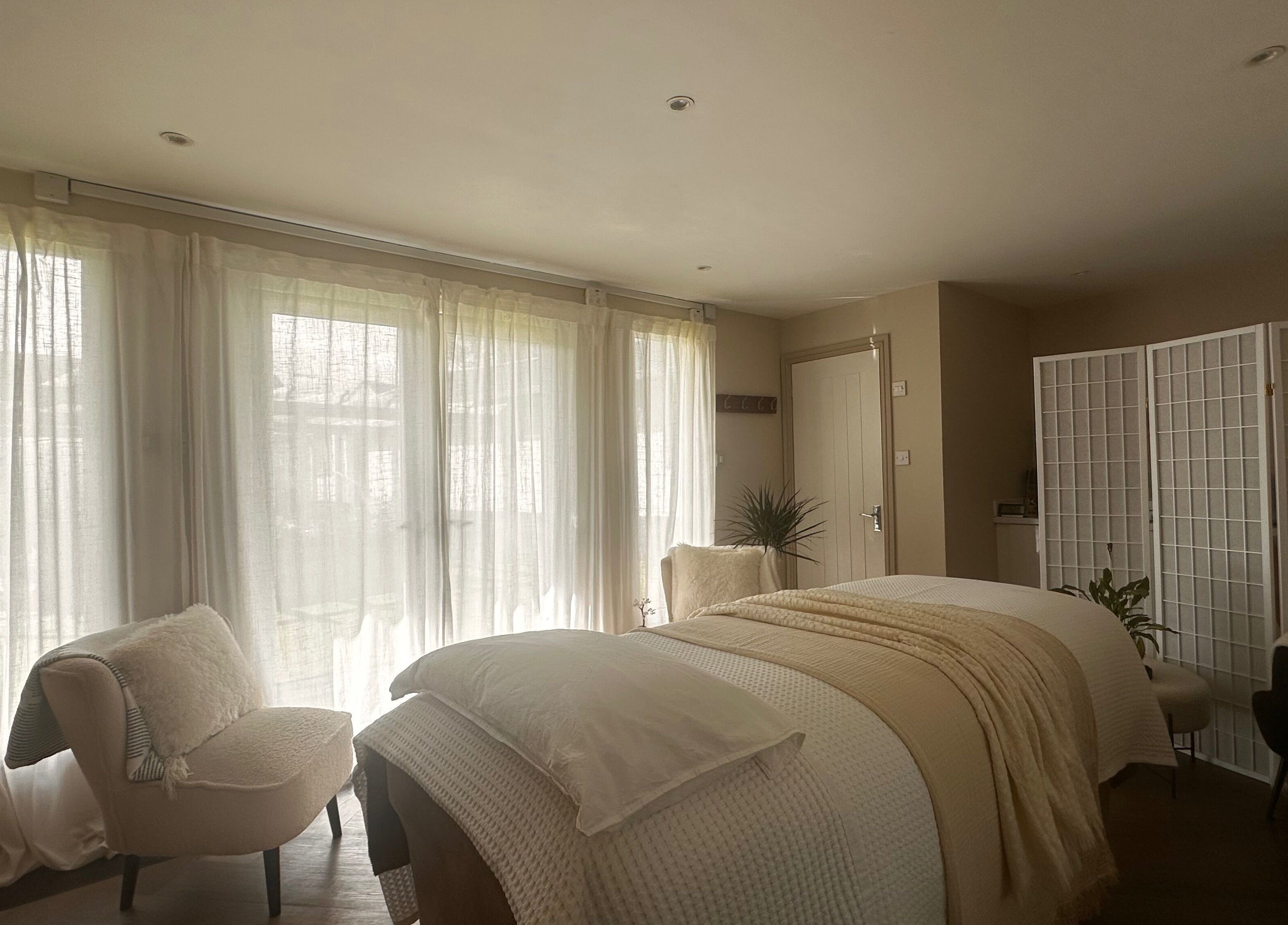 Tranquil treatment room at Soul Skin Studio and Wellness, Blantyre, GB with elegant neutral decor and soft lighting.