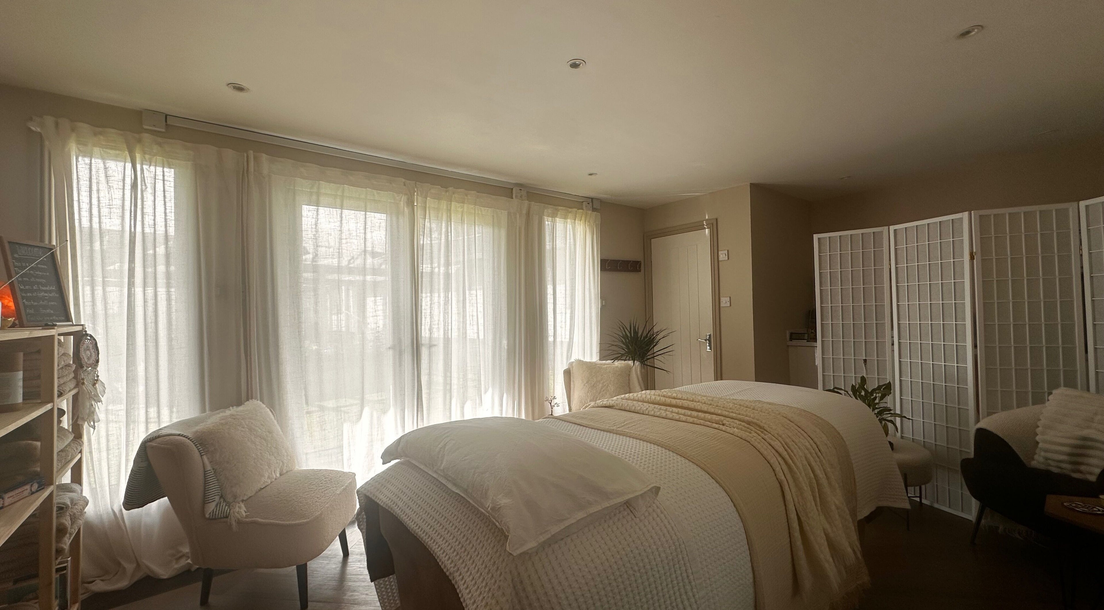 Tranquil treatment room at Soul Skin Studio and Wellness, Blantyre, GB with elegant neutral decor and soft lighting.