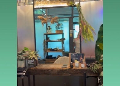 Lobby at Korea Head Spa TTDI by Emmebi Hair Salon, Kuala Lumpur. Decorated with lush plants and earthy tones.