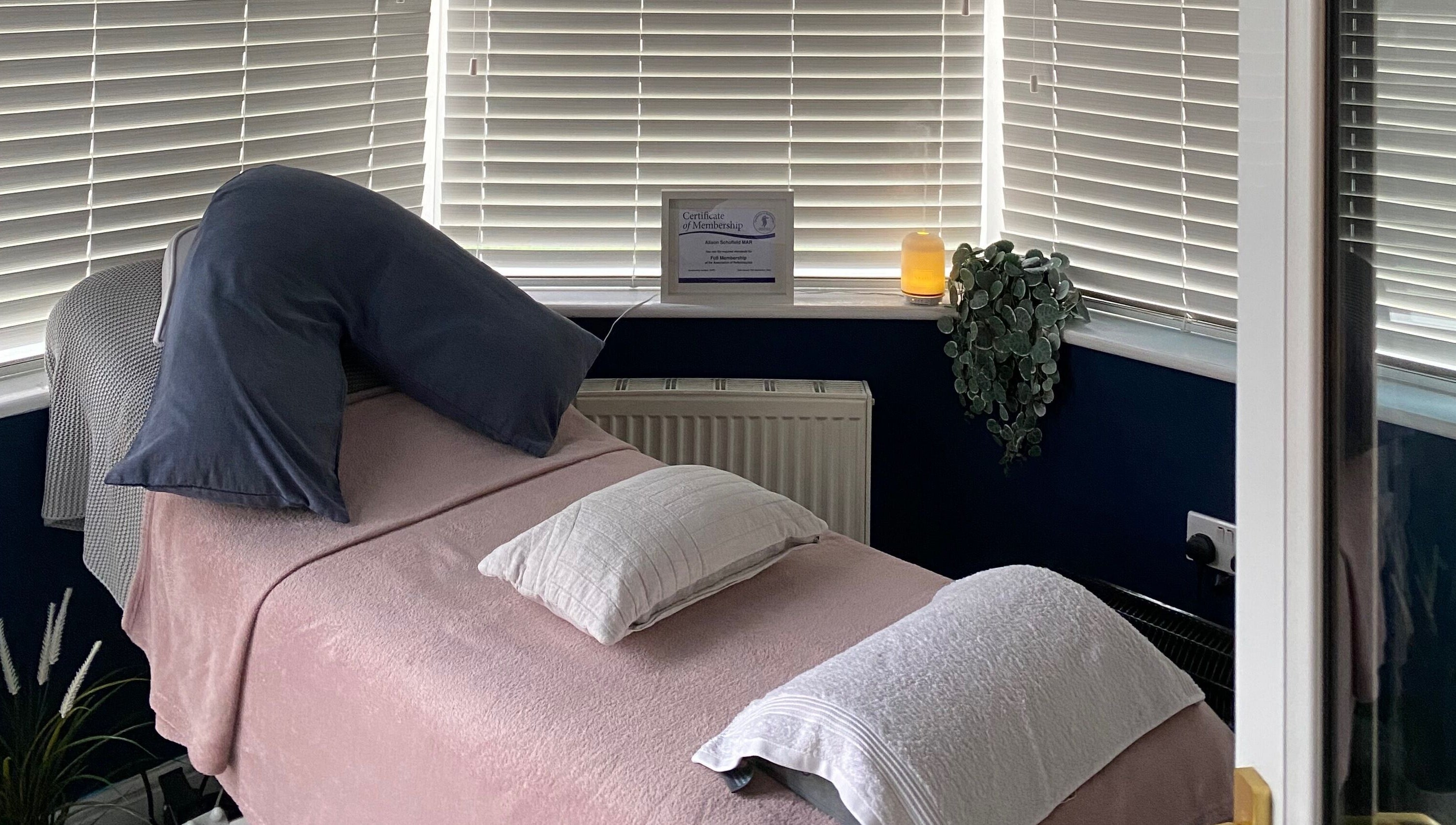 Cozy treatment room at Inner Balance Clinical Reflexology, Methley, England, GB, with a softly lit ambiance.