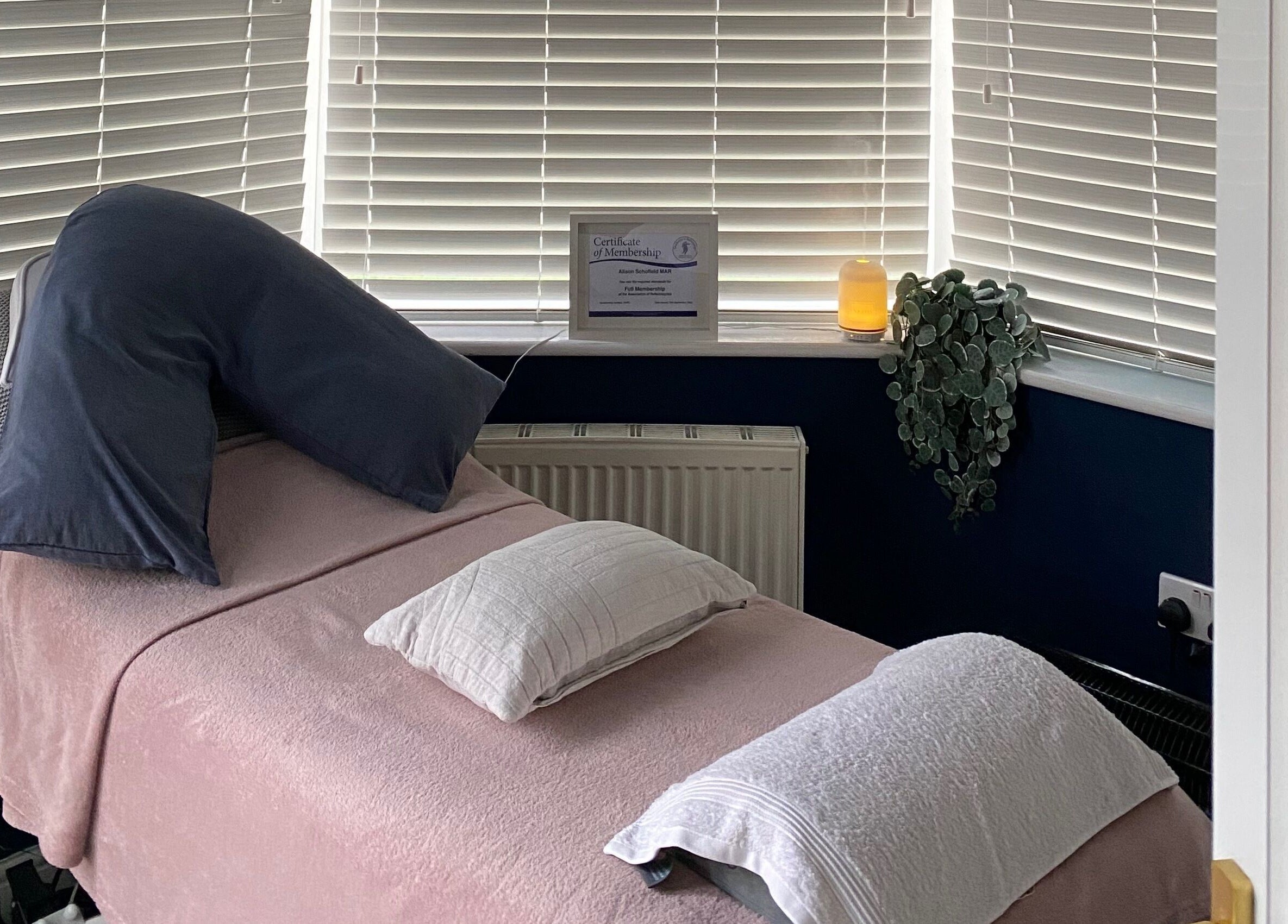 Cozy treatment room at Inner Balance Clinical Reflexology, Methley, England, GB, with a softly lit ambiance.