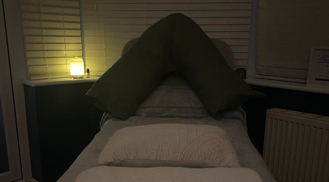 Tranquil therapy room at Inner Balance Clinical Reflexology, Methley, England, with soft lighting and serene bedding.