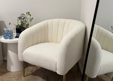 Comfortable seating area with white chair at Victoria Makeup Artistry, Mickleham, Victoria, AU.