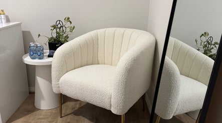 Comfortable seating area with white chair at Victoria Makeup Artistry, Mickleham, Victoria, AU.