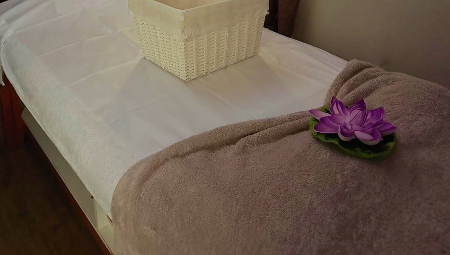 Massage table with towel and flower at Shellharbour Village Thai Massage in Shellharbour, New South Wales, AU.