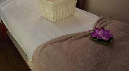 Massage table with towel and flower at Shellharbour Village Thai Massage in Shellharbour, New South Wales, AU.
