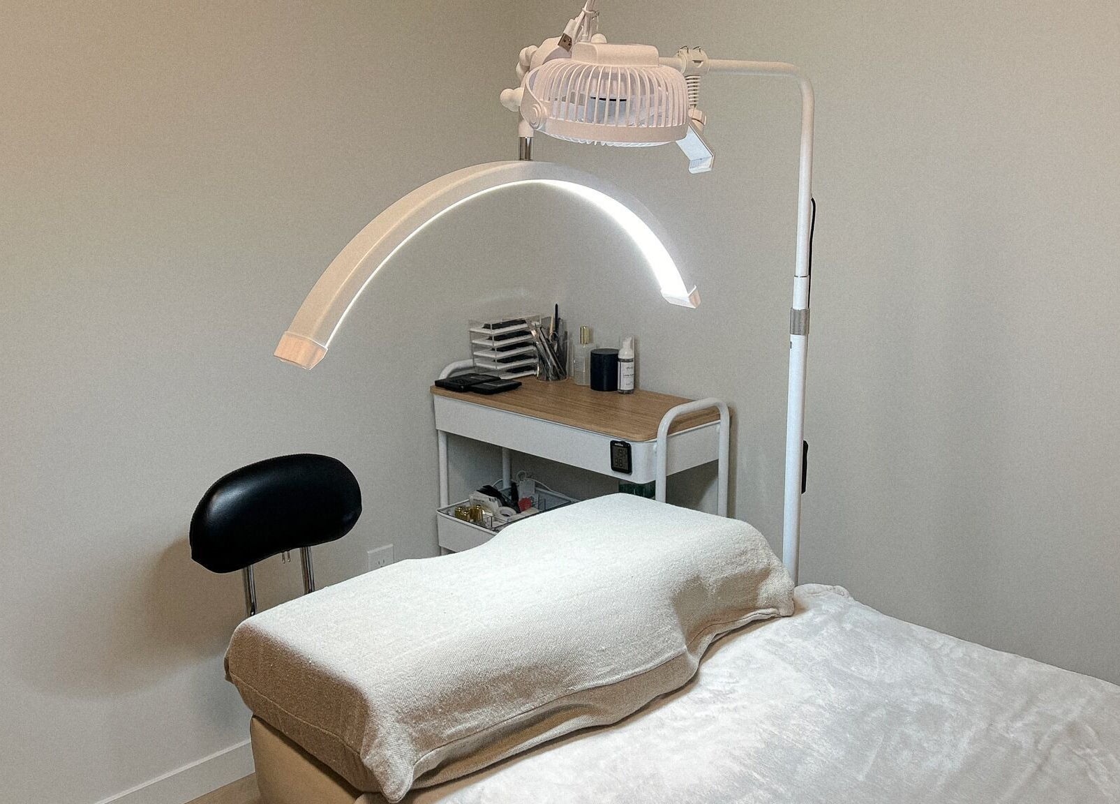 Cozy treatment room at Alison Siaotong Studio, Edmonton, Alberta, CA, equipped with a bed and modern lighting.
