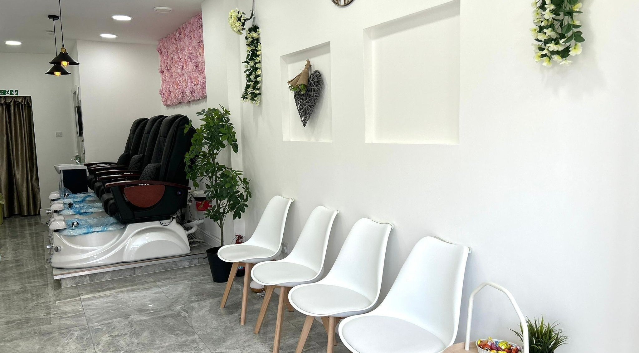 Seating and pedicure chairs at Blissful Nail Studio, London, England, GB with elegant decor.