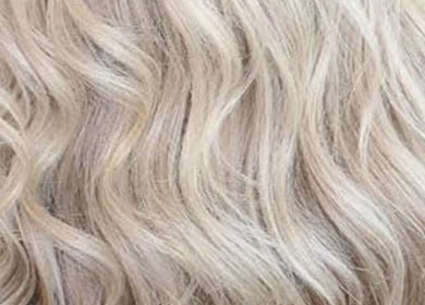 Blonde wavy hair styled at CORR Hair Artistry in Edgeworth, New South Wales, AU.
