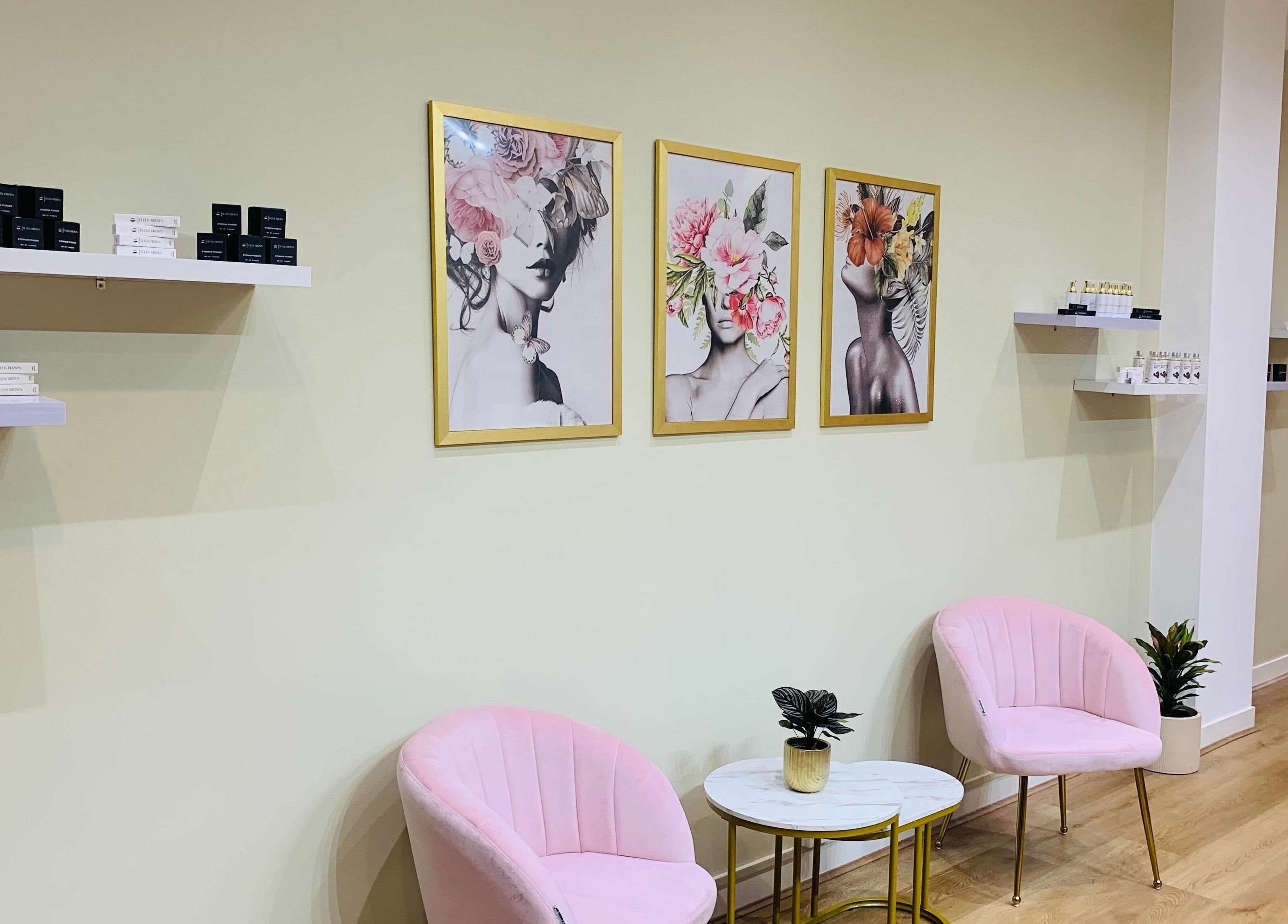 Chic lounge at Fleek Brows, Prahran, Victoria with art and pink chairs.