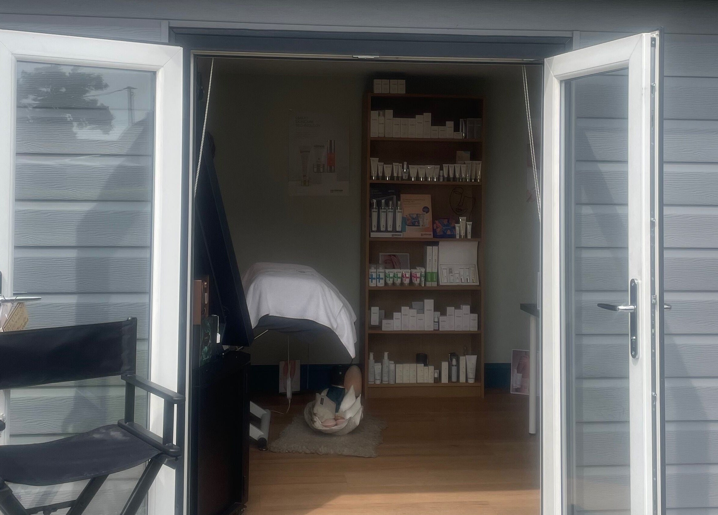 Open door to The Beauty Hideout in Goosnargh, England, GB, showcasing a serene treatment room.