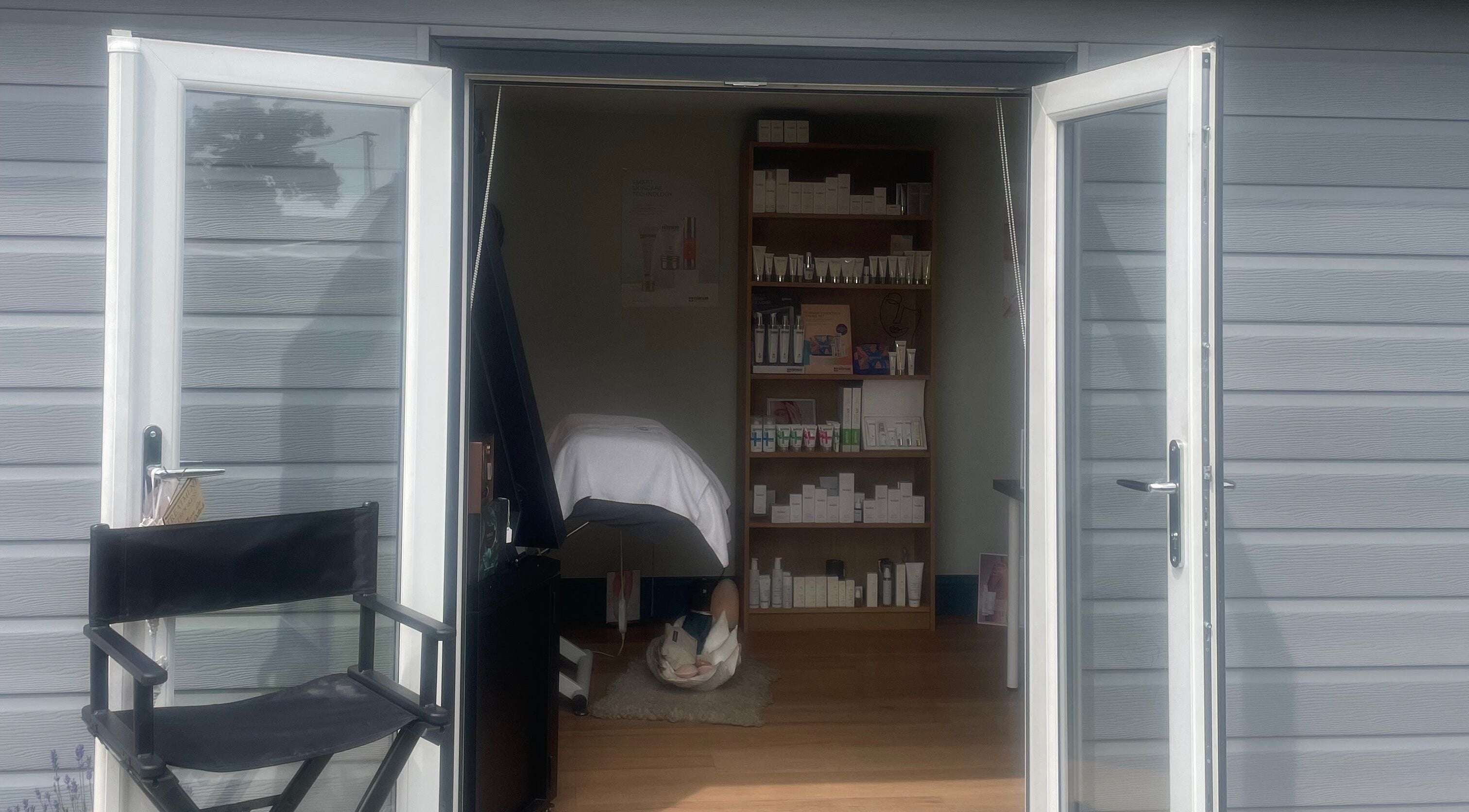 Open door to The Beauty Hideout in Goosnargh, England, GB, showcasing a serene treatment room.