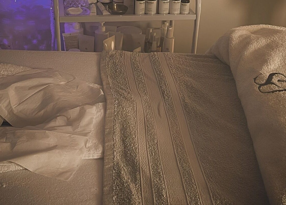 Relaxing spa bed setup at The Beauty Hideout in Goosnargh, England, GB, with towels and soft lighting.