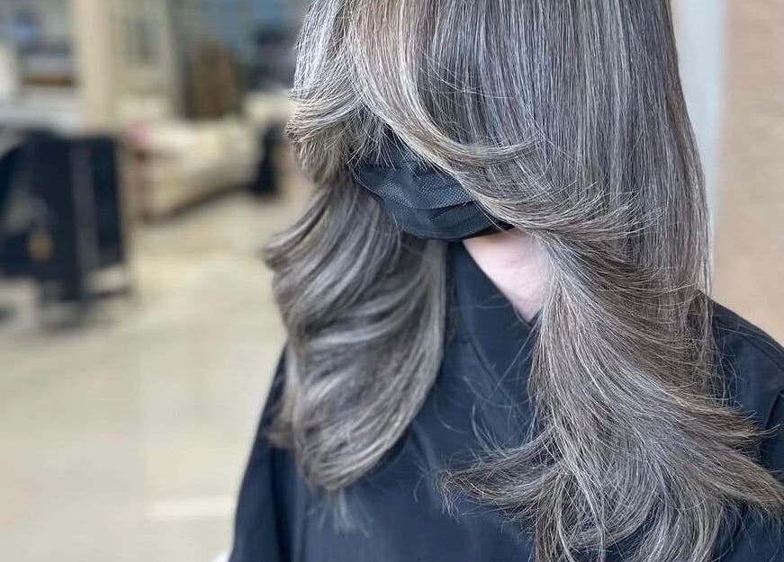 Stylishly layered silver hair at Silver Hair - Al Khobar, Eastern Province, SA, showcasing expert salon skills.