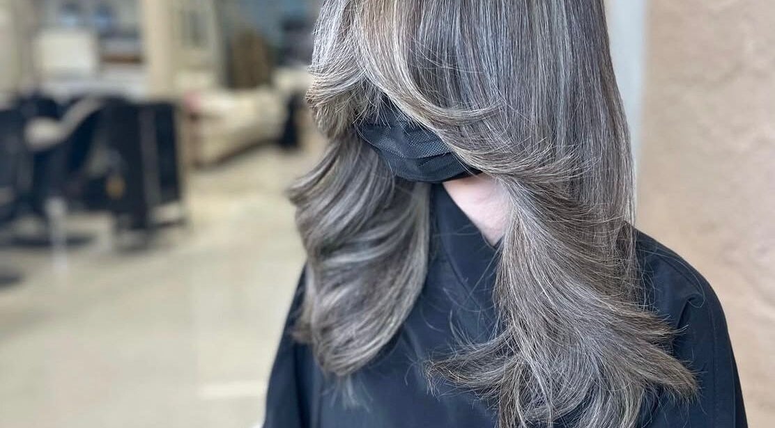 Stylishly layered silver hair at Silver Hair - Al Khobar, Eastern Province, SA, showcasing expert salon skills.