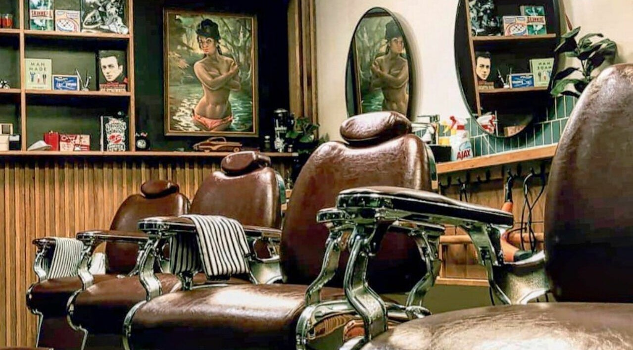 Classic barber chairs inside The Gold Standard Barbershop in Melbourne, Victoria, AU, exuding vintage charm.