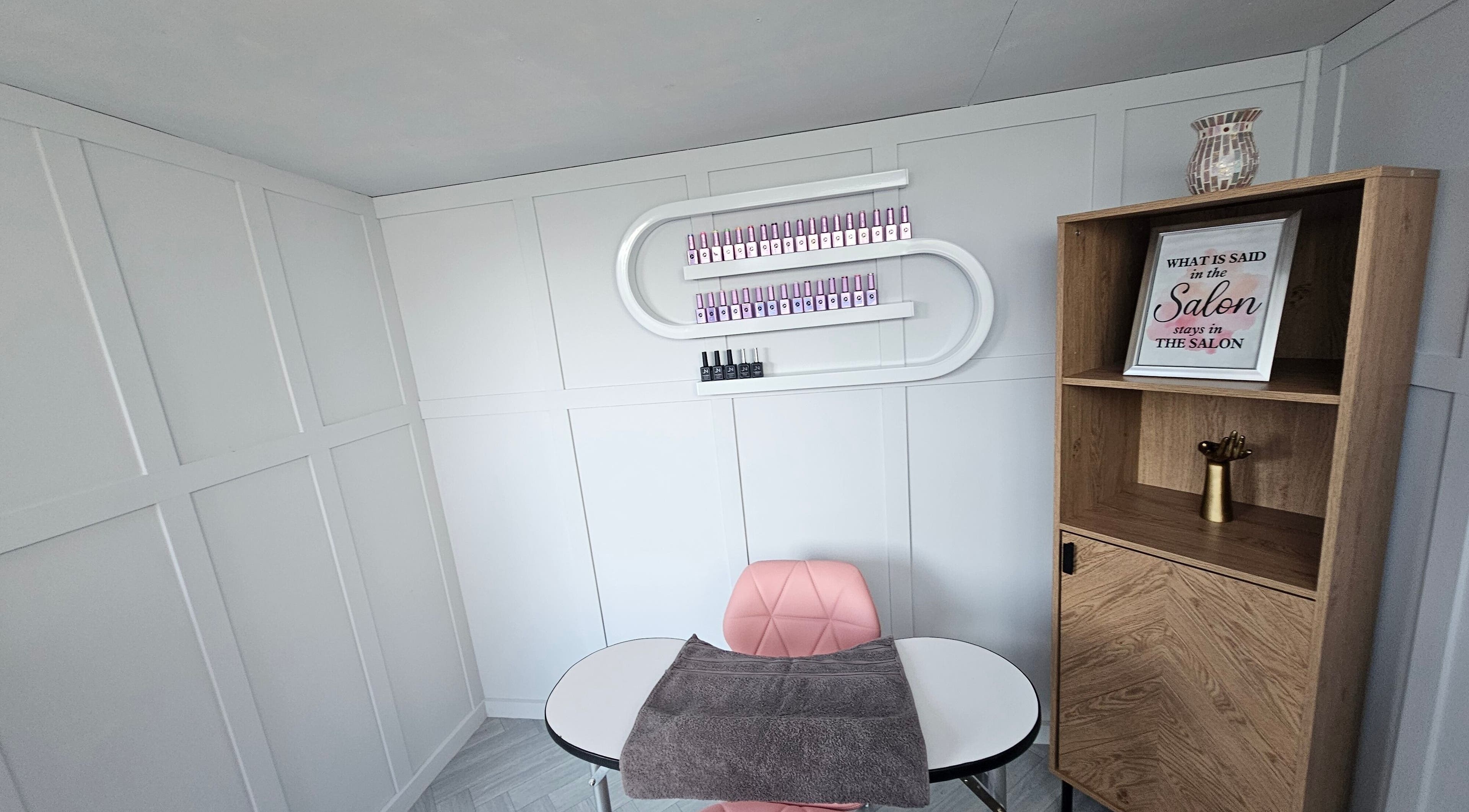 Modern salon corner at Bella Tu, Haverhill, England, GB with pink chair, manicure table, and product display.