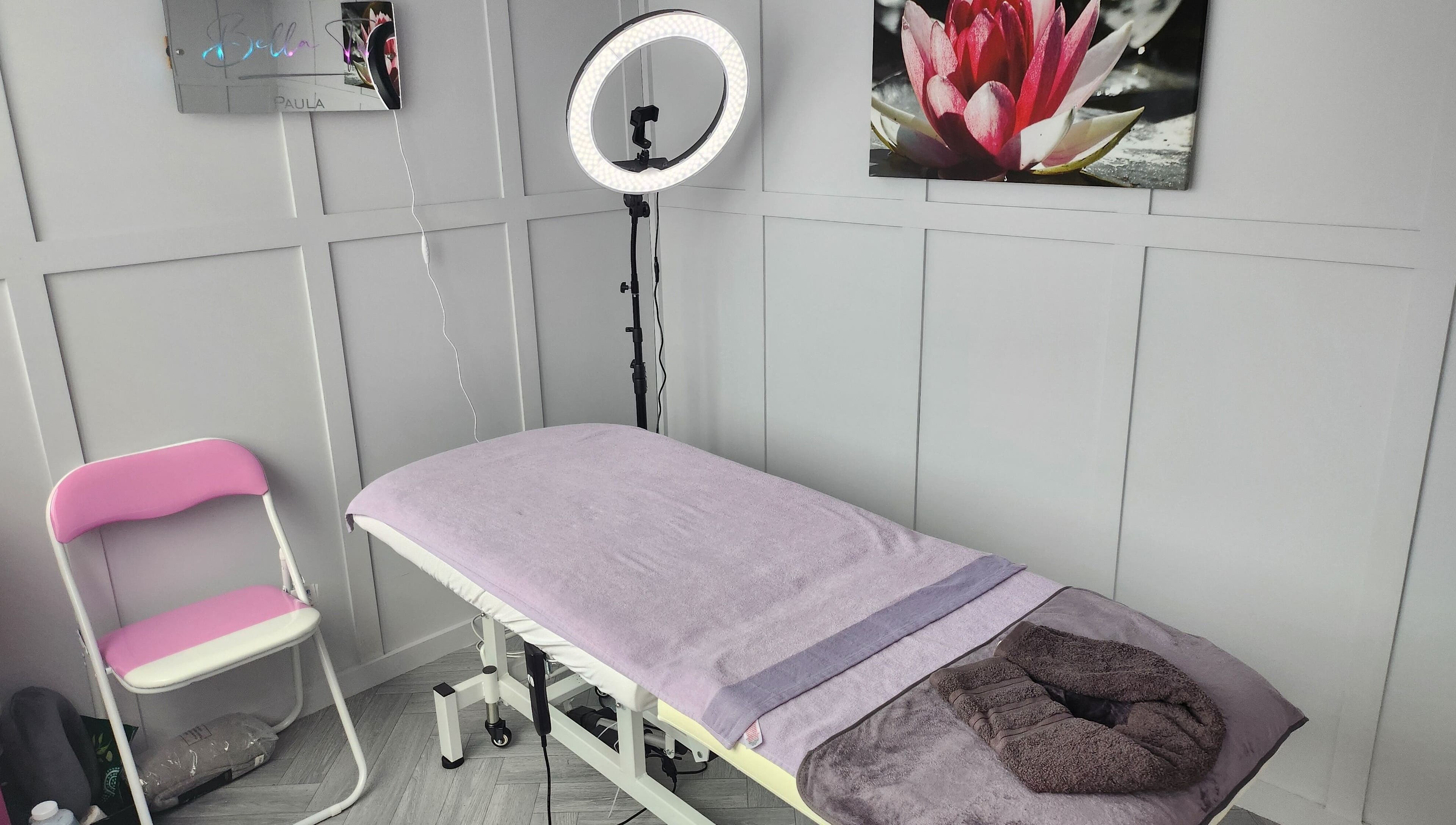 Serene treatment room at Bella Tu, Haverhill, England, GB with massage bed and calming decor.