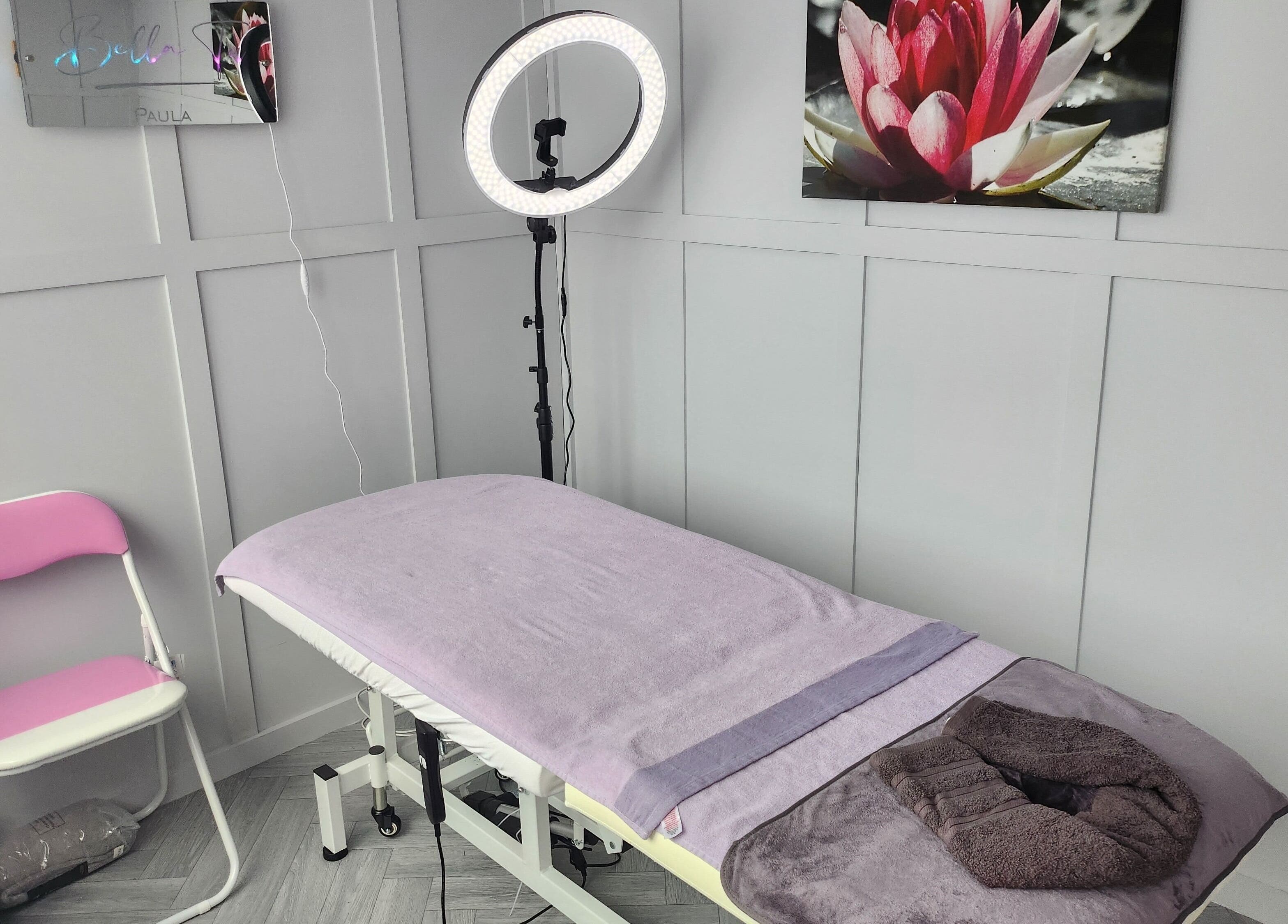 Serene treatment room at Bella Tu, Haverhill, England, GB with massage bed and calming decor.