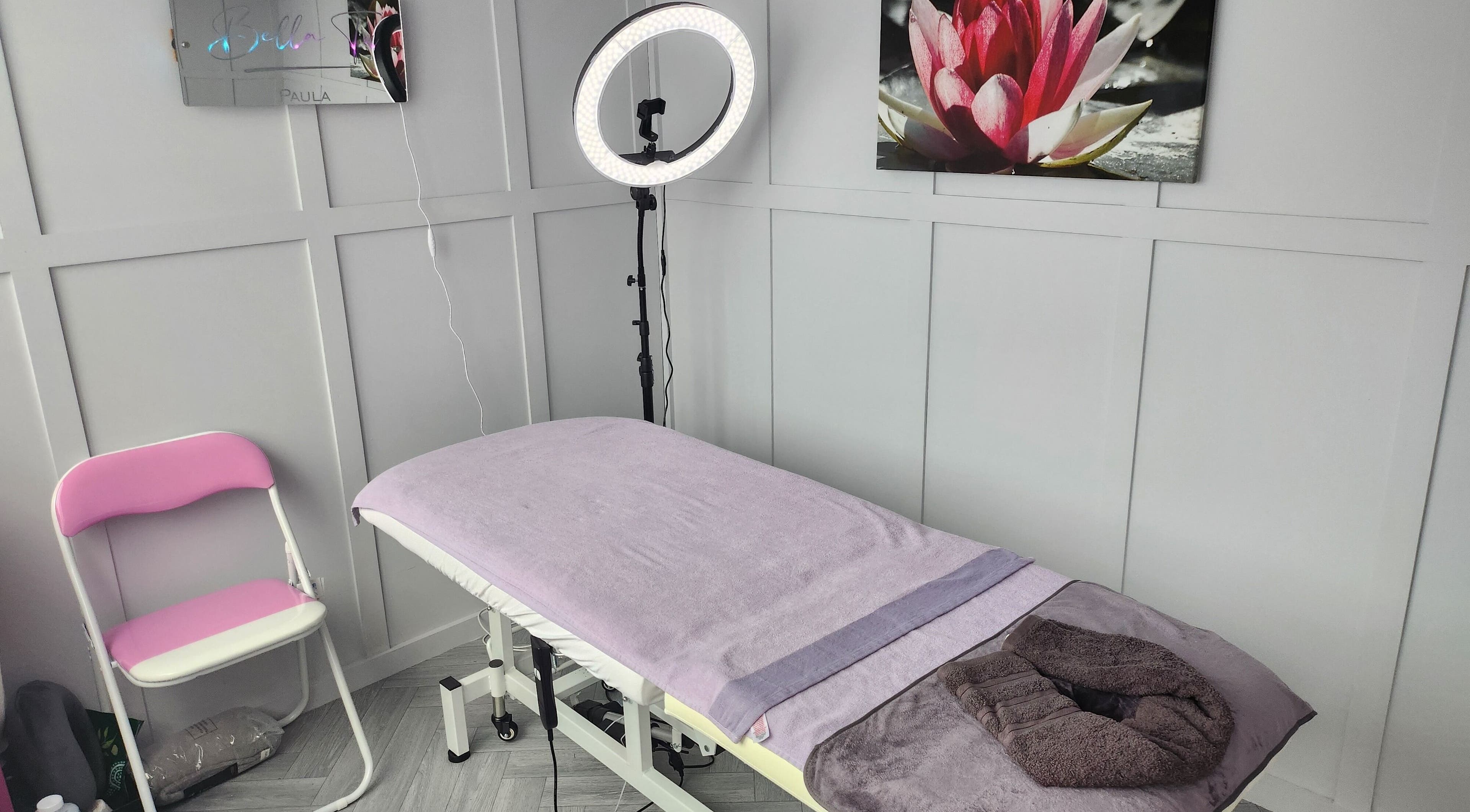 Serene treatment room at Bella Tu, Haverhill, England, GB with massage bed and calming decor.