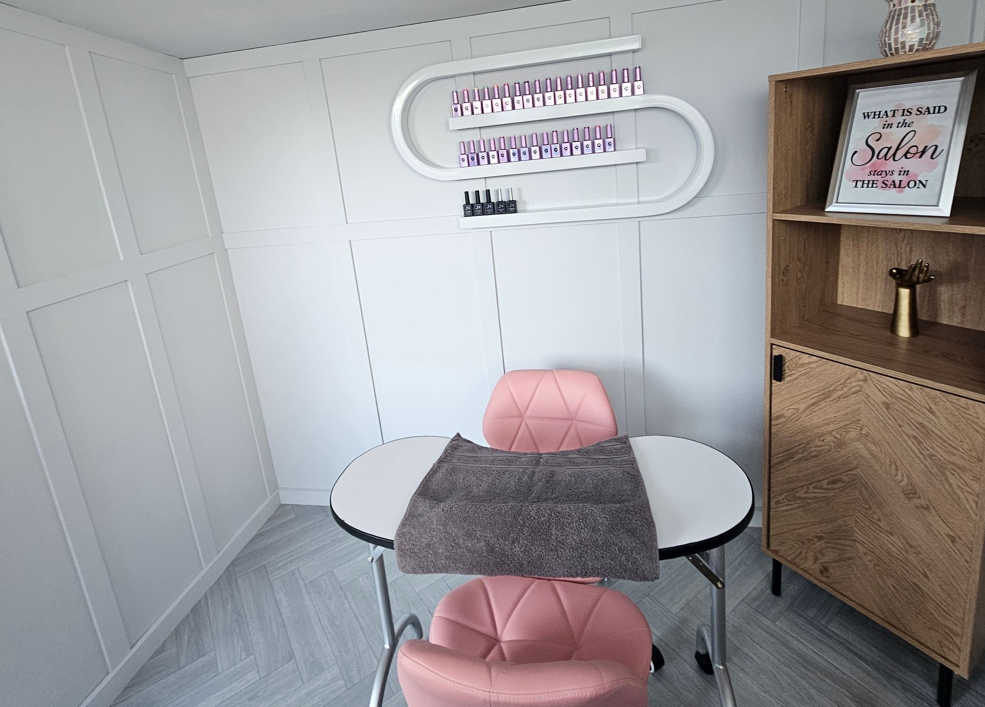Elegant manicure station at Bella Tu, Haverhill, England, GB, featuring pink chairs and modern decor.