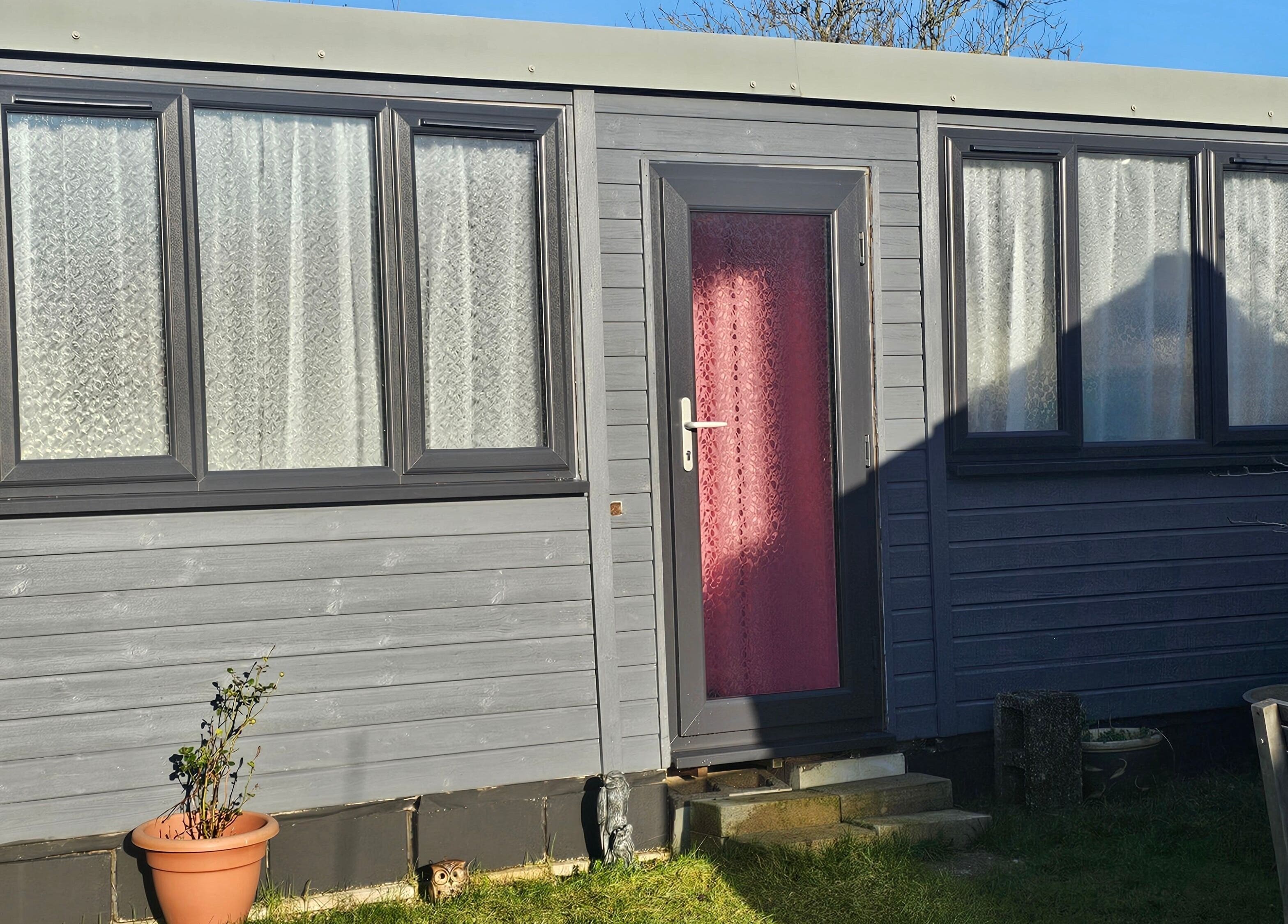 Cozy grey studio cabin at Bella Tu, Haverhill, England, GB, showcasing comfortable exterior design.