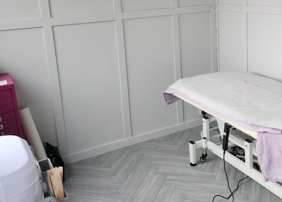 Relaxing treatment room at Bella Tu, Haverhill, England, GB, featuring a modern massage table and elegant decor.