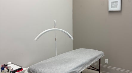 Treatment room at Elysium Beauty Clinic - Hanna Savinykh in Vaughan, Ontario, CA, showcasing a massage bed.