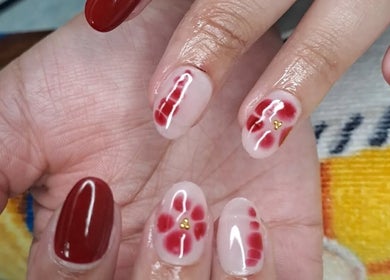 Elegant red floral nail art at Nailed by Chels in Cape Town, Western Cape, ZA.