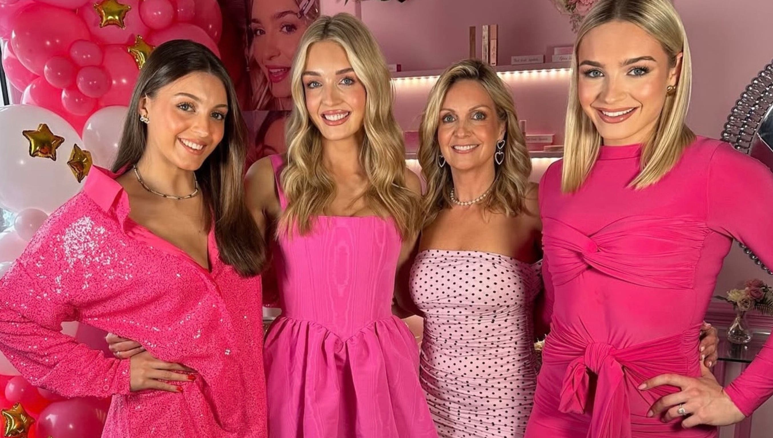 Guests enjoying a pink-themed event at Lady Gray, Wesham, England, GB with vibrant outfits and decor.