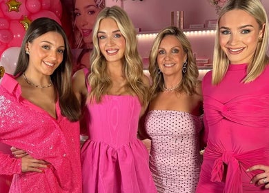 Guests enjoying a pink-themed event at Lady Gray, Wesham, England, GB with vibrant outfits and decor.