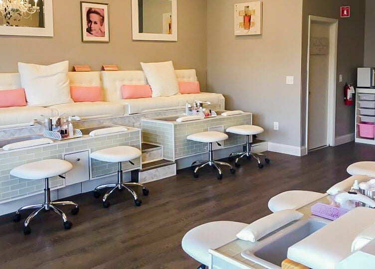 Relaxing, chic interior of New Beauty Nail Lounge and Spa in Bellingham, Massachusetts, US, showcasing pedicure stations.