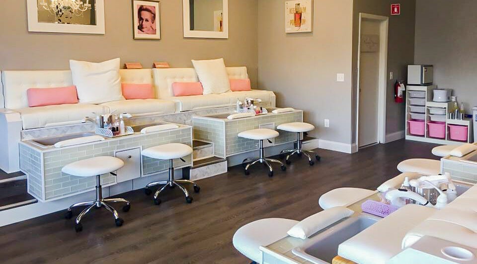 Relaxing, chic interior of New Beauty Nail Lounge and Spa in Bellingham, Massachusetts, US, showcasing pedicure stations.