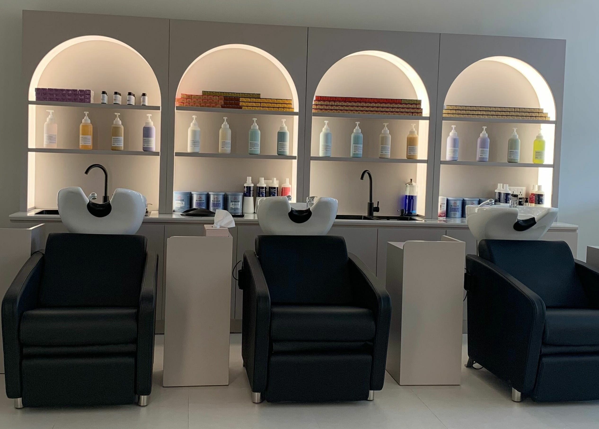Modern hair wash stations at Sasalon Dubai, Dubai, AE. Sleek black chairs and premium hair products displayed stylishly.