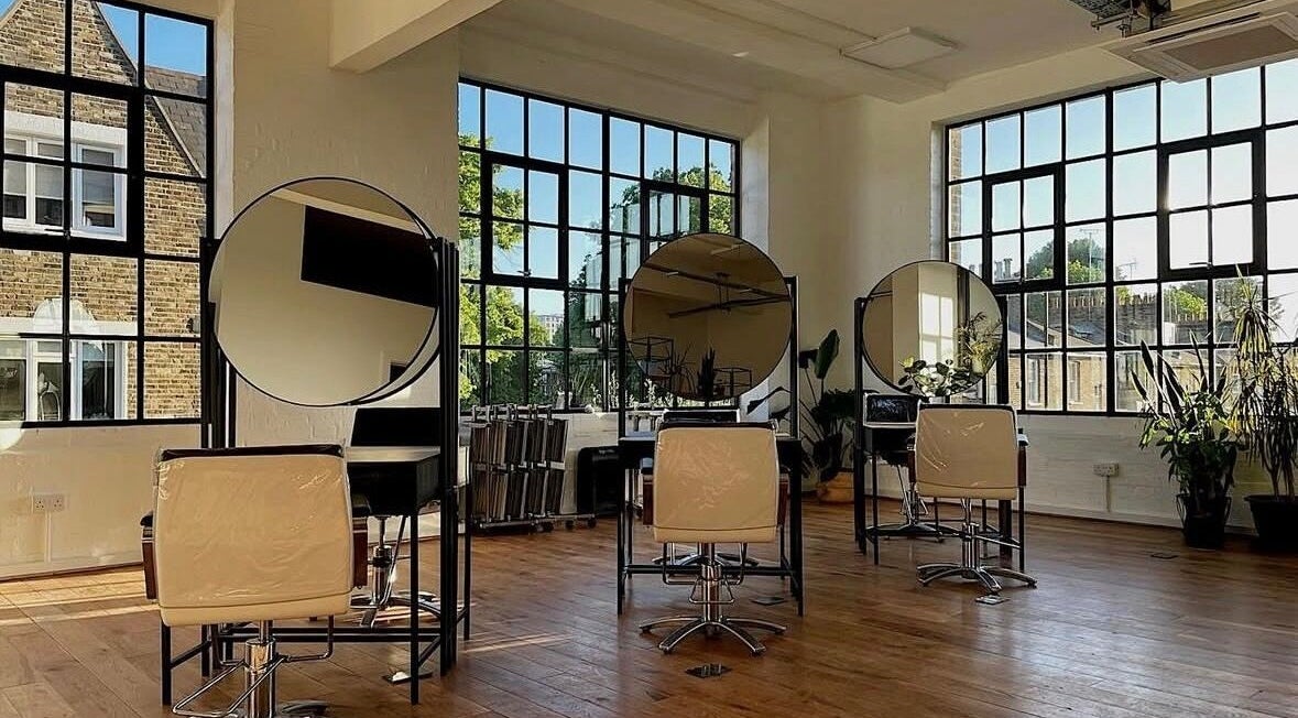 Bright, spacious salon area at Solar Haar at Studio 90, London, England, GB with modern styling chairs and mirrors.
