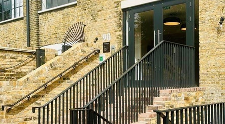 Entrance of Solar Haar at Studio 90 in London, England, GB with modern black railing on brick steps.