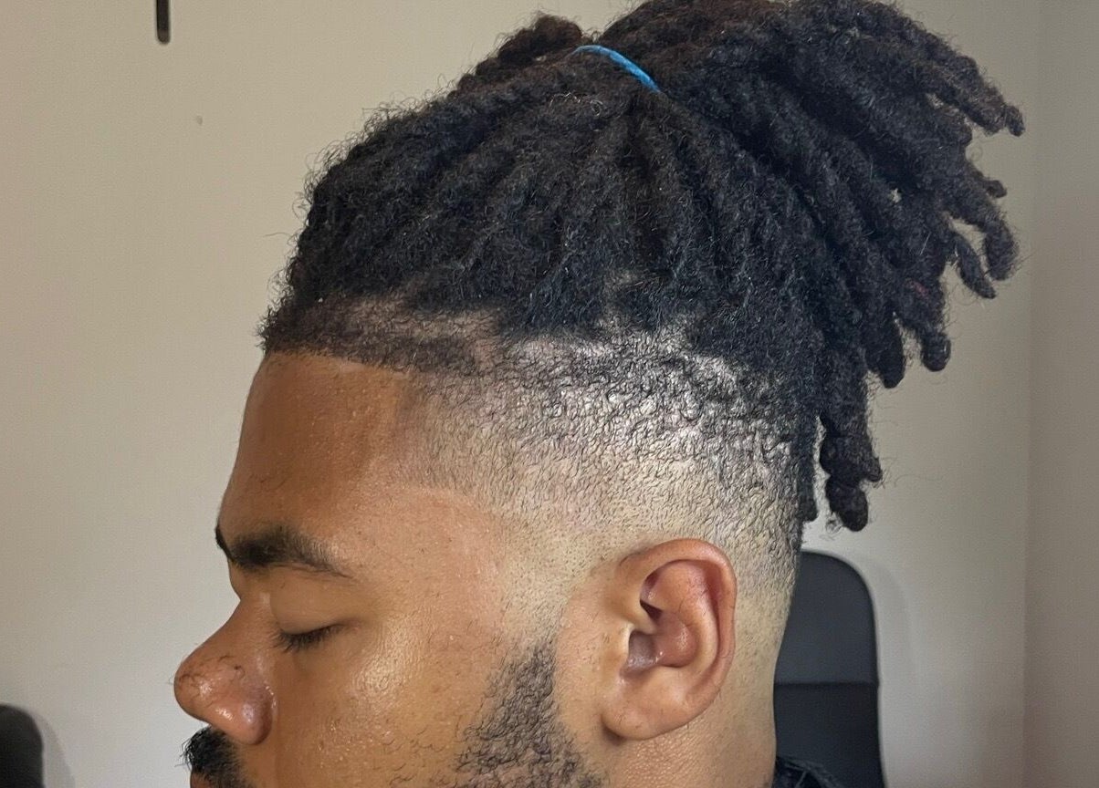 Detailed dreadlock style on a man at D.A Cutz, Halifax, Nova Scotia, CA.